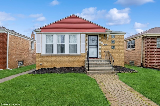 bungalow-style home with brick siding and a front yard