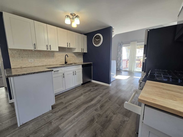 kitchen with dishwashing machine, white cabinets, backsplash, and a sink