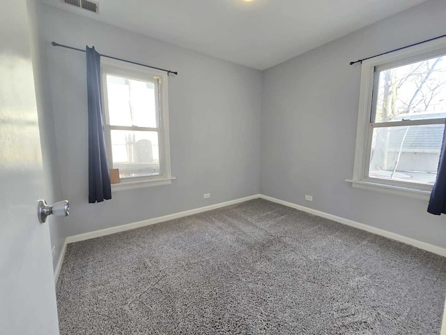 spare room with visible vents, baseboards, and carpet floors