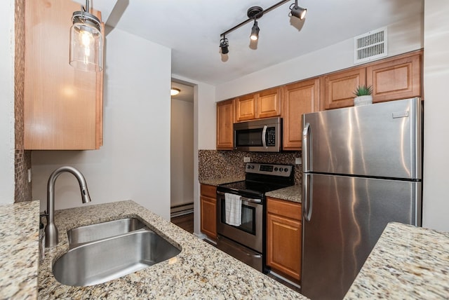 kitchen with visible vents, a sink, tasteful backsplash, appliances with stainless steel finishes, and baseboard heating