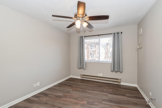 empty room with dark wood-style floors, baseboard heating, baseboards, and ceiling fan