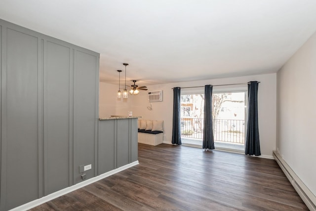 unfurnished living room featuring dark wood-type flooring, baseboard heating, and an AC wall unit