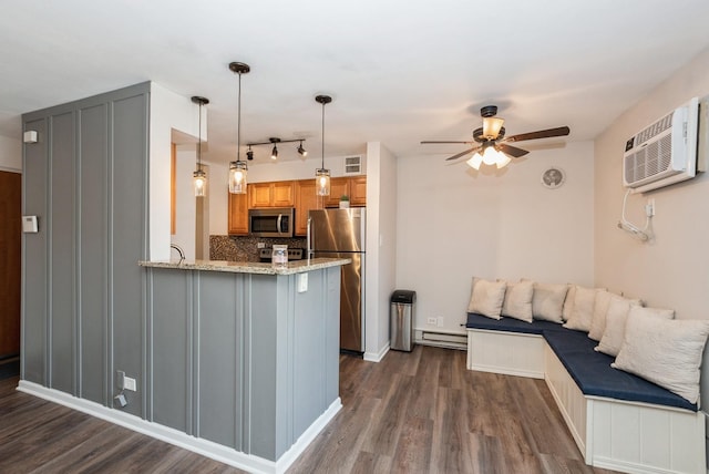 kitchen featuring dark wood-type flooring, tasteful backsplash, appliances with stainless steel finishes, a baseboard radiator, and ceiling fan