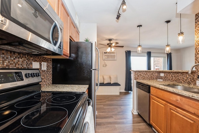 kitchen with ceiling fan, decorative backsplash, dark wood-type flooring, a sink, and appliances with stainless steel finishes