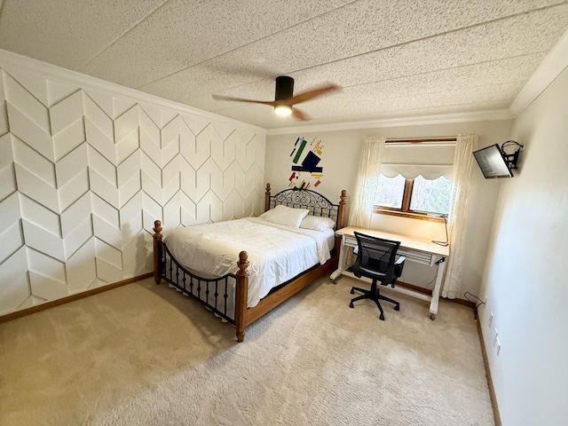 bedroom with ceiling fan, baseboards, light colored carpet, and ornamental molding