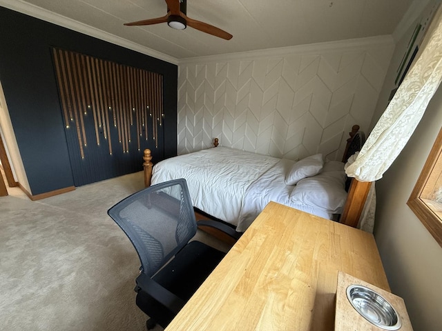 carpeted bedroom featuring ceiling fan and ornamental molding