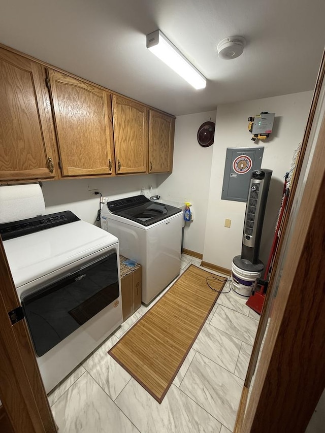 washroom with baseboards, cabinet space, marble finish floor, and washer and clothes dryer