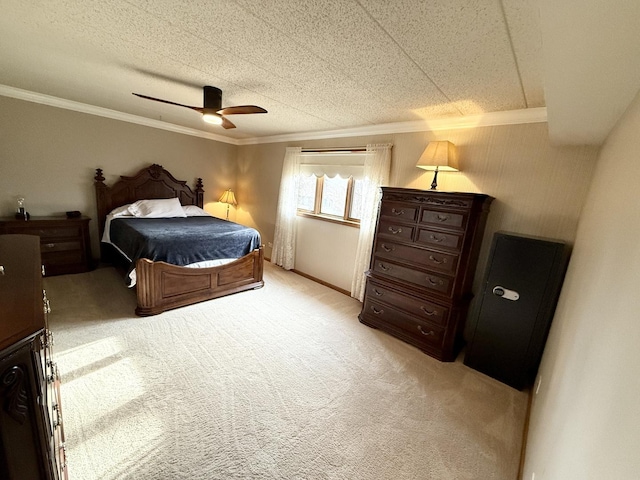 bedroom with a textured ceiling, light carpet, a ceiling fan, and ornamental molding