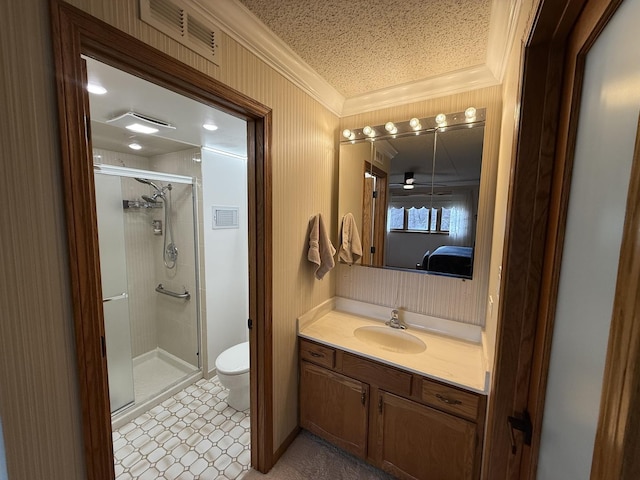 full bathroom with visible vents, toilet, ornamental molding, a stall shower, and vanity