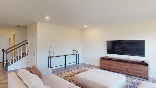 living room featuring recessed lighting, stairs, baseboards, and wood finished floors