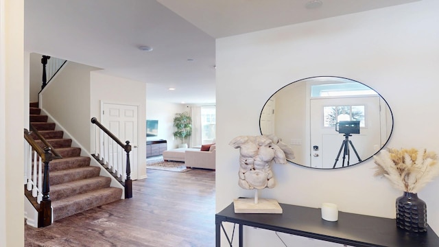 foyer featuring recessed lighting, stairs, and wood finished floors