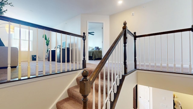 staircase featuring baseboards and carpet