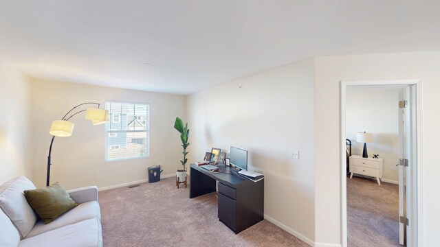 office with light colored carpet and baseboards