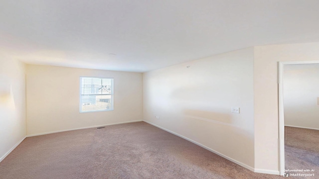 carpeted empty room featuring baseboards