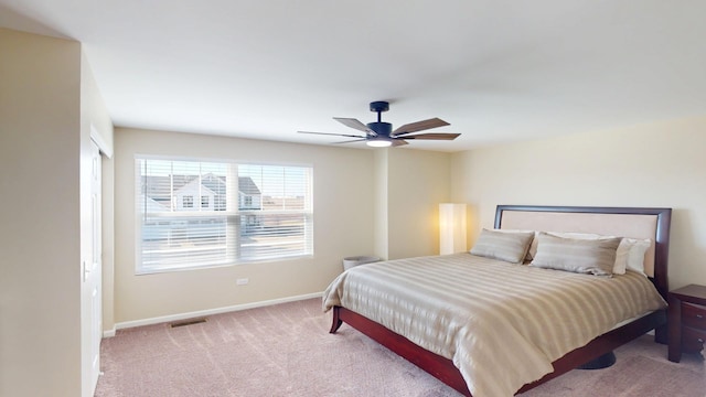 bedroom featuring a ceiling fan, baseboards, visible vents, and carpet floors