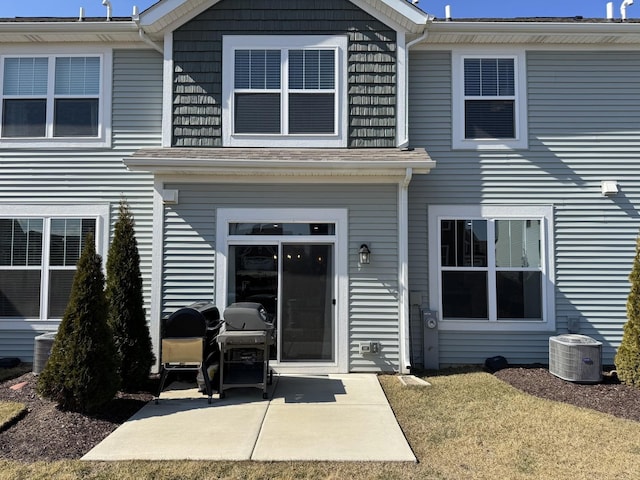 back of property featuring cooling unit and a patio area