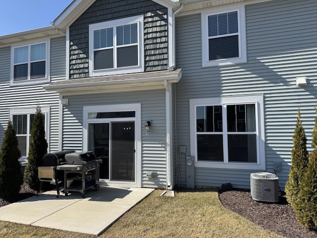 back of house featuring central AC unit and a patio