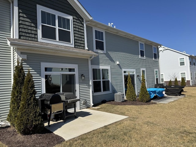 back of property with a patio area and a lawn