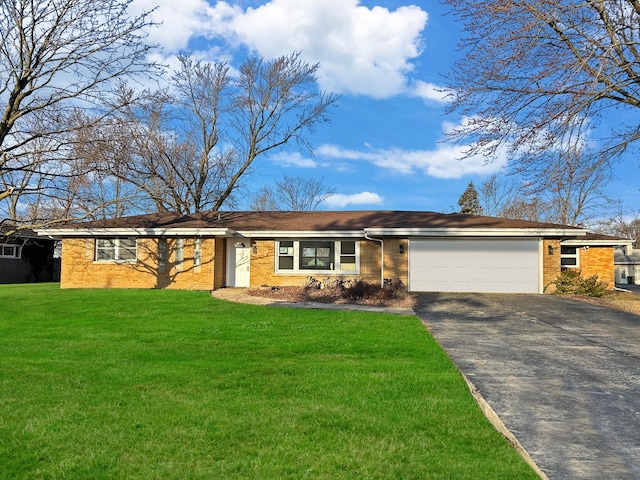 ranch-style home with brick siding, a garage, driveway, and a front lawn