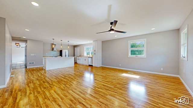 unfurnished living room with recessed lighting, visible vents, ceiling fan, and light wood-style floors