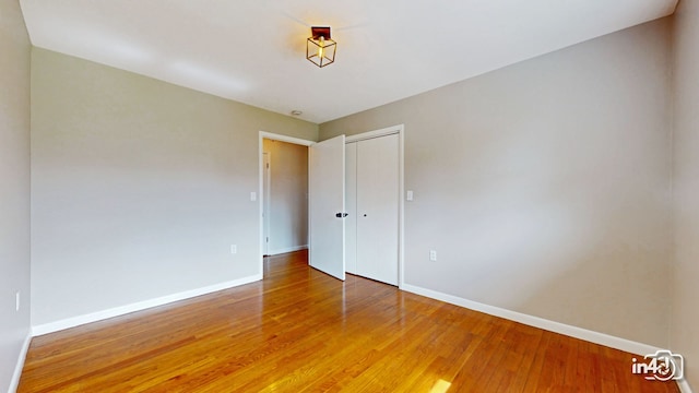 empty room with wood finished floors and baseboards