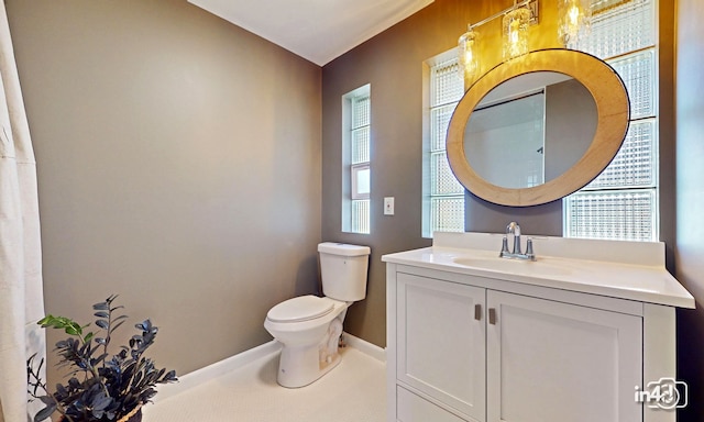 bathroom featuring tile patterned floors, toilet, vanity, and baseboards