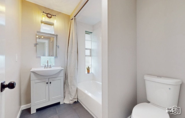 bathroom with vanity, baseboards, shower / bath combo with shower curtain, tile patterned floors, and toilet