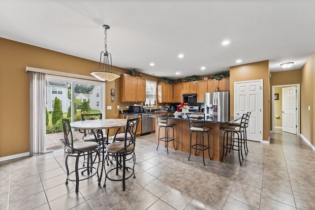 dining area with light tile patterned floors, recessed lighting, and baseboards