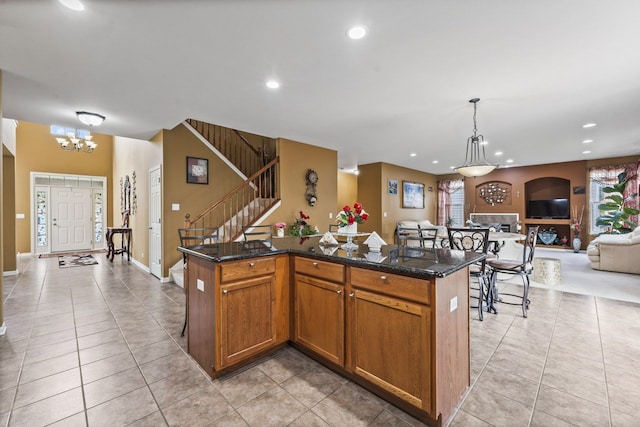 kitchen featuring a center island, open floor plan, recessed lighting, hanging light fixtures, and a notable chandelier