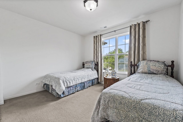 carpeted bedroom with baseboards and visible vents