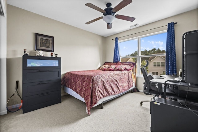 carpeted bedroom featuring visible vents, baseboards, and a ceiling fan