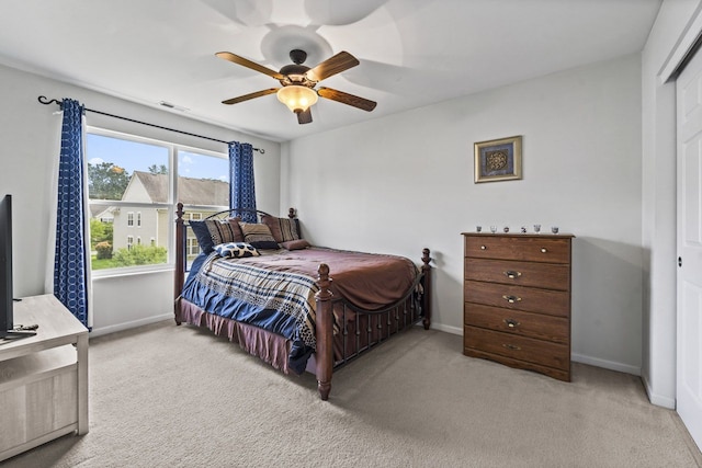 carpeted bedroom featuring a ceiling fan, baseboards, and visible vents