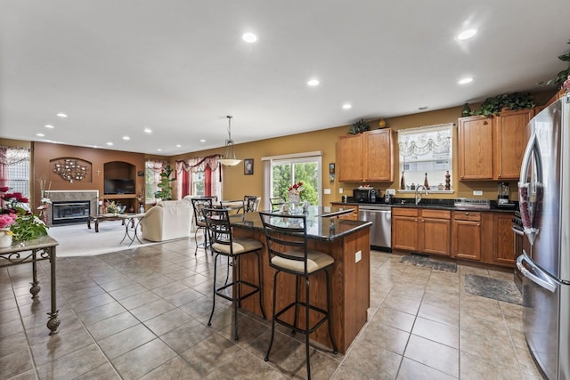 kitchen with a kitchen bar, recessed lighting, and stainless steel appliances