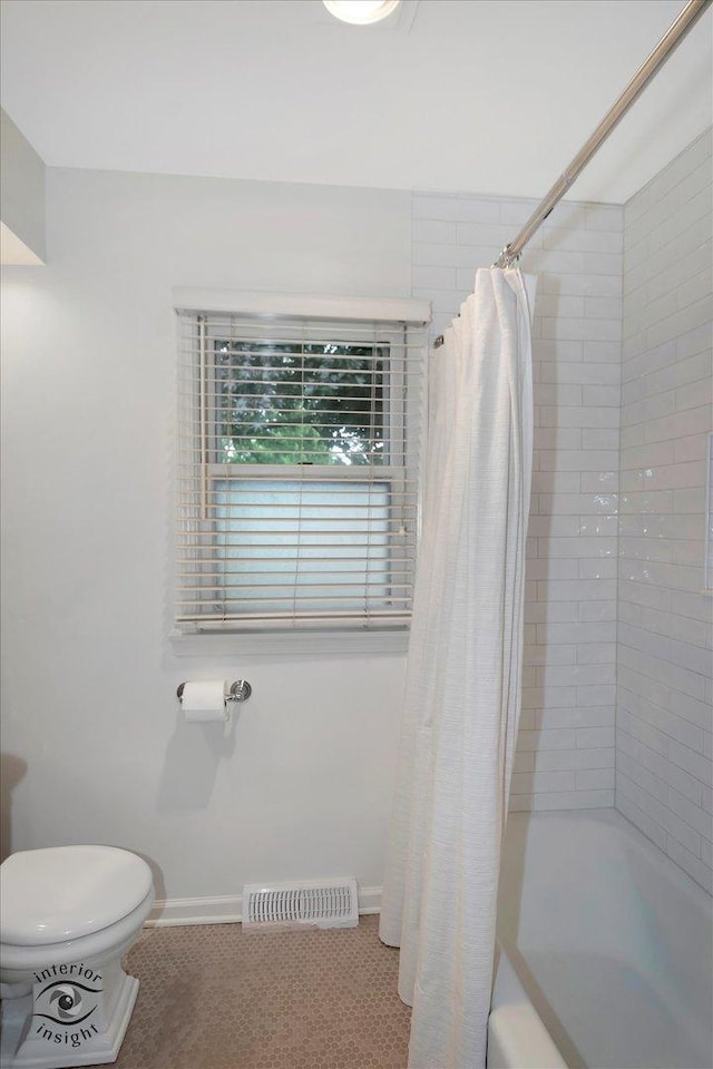 27W213 Manchester Rd, Winfield, IL 60190 - bathroom featuring shower / bathtub combination with curtain, toilet, and baseboards