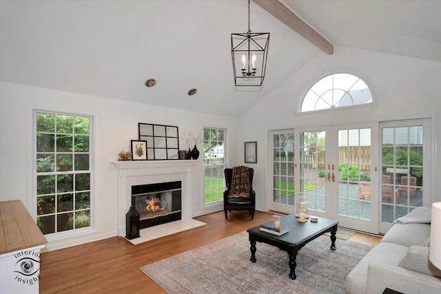 27W213 Manchester Rd, Winfield, IL 60190 - living room with beamed ceiling, a fireplace with flush hearth, a chandelier, wood finished floors, and high vaulted ceiling