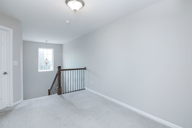 spare room with carpet and baseboards