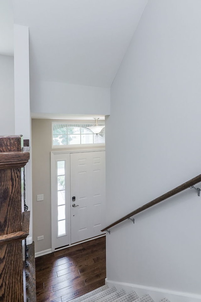 entryway with baseboards, lofted ceiling, and dark wood-style floors