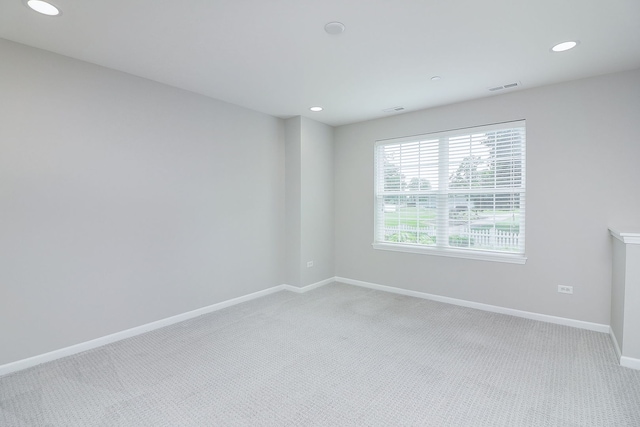 spare room with visible vents, recessed lighting, carpet flooring, and baseboards