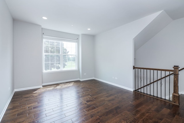 empty room with recessed lighting, baseboards, and dark wood finished floors