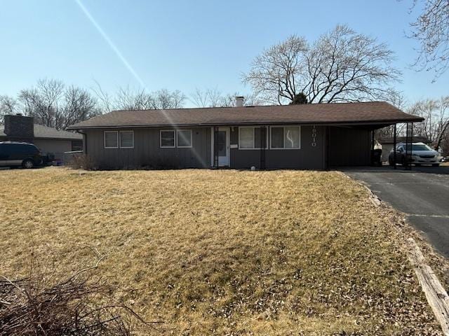 single story home with a carport, driveway, and a front lawn