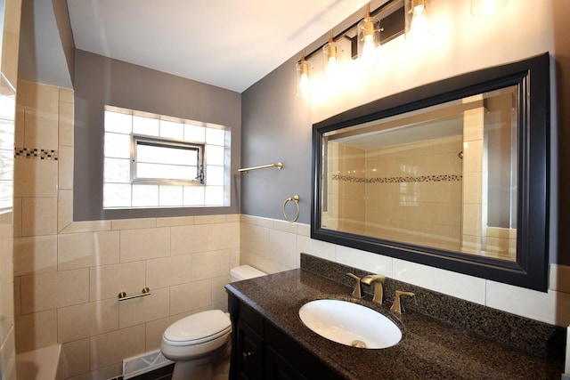 full bath featuring vanity, visible vents, a shower, tile walls, and toilet