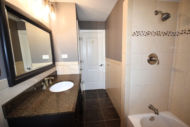 full bathroom with shower / bath combination, vanity, tile walls, and wainscoting