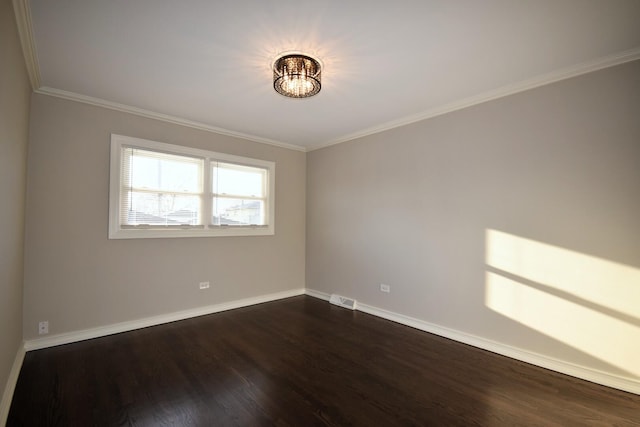 unfurnished room featuring visible vents, baseboards, dark wood-type flooring, and crown molding