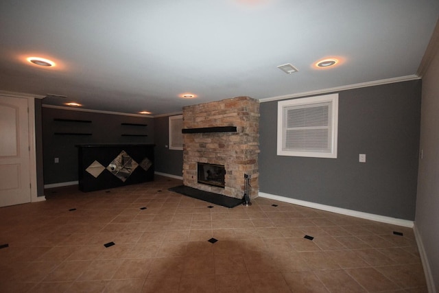 unfurnished living room featuring a stone fireplace, baseboards, and ornamental molding