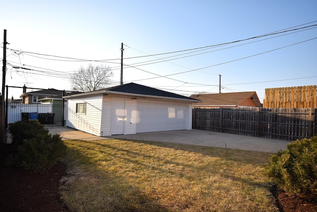 detached garage featuring fence