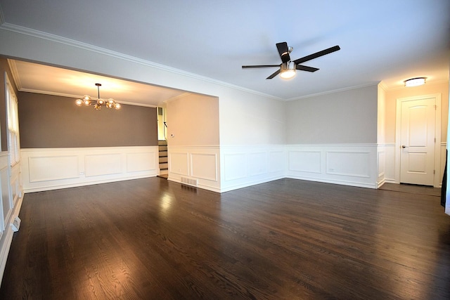 unfurnished room with a wainscoted wall, ceiling fan with notable chandelier, dark wood-style flooring, and ornamental molding