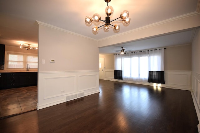 interior space with visible vents, a sink, dark wood-type flooring, crown molding, and a chandelier