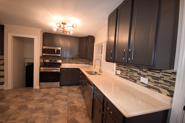 kitchen featuring a sink, stainless steel appliances, decorative backsplash, and light countertops