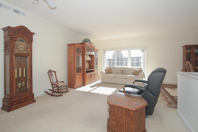 living room with light colored carpet, visible vents, and baseboards