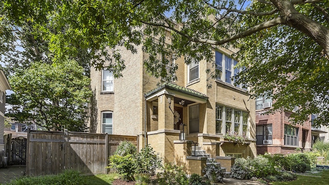 exterior space featuring fence and brick siding